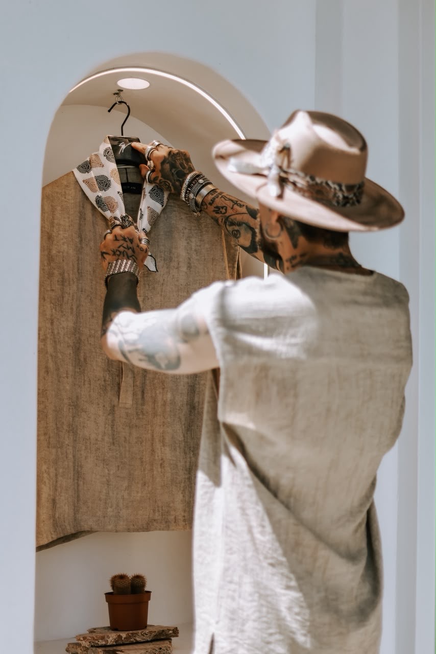 Stefanos Kaimaktsis presenting a linen garment inside the store